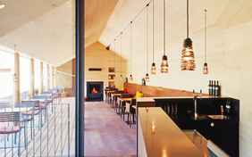 Frühstücksbereich mit Terrasse und Rezeption im sonnigen Zwischentrakt